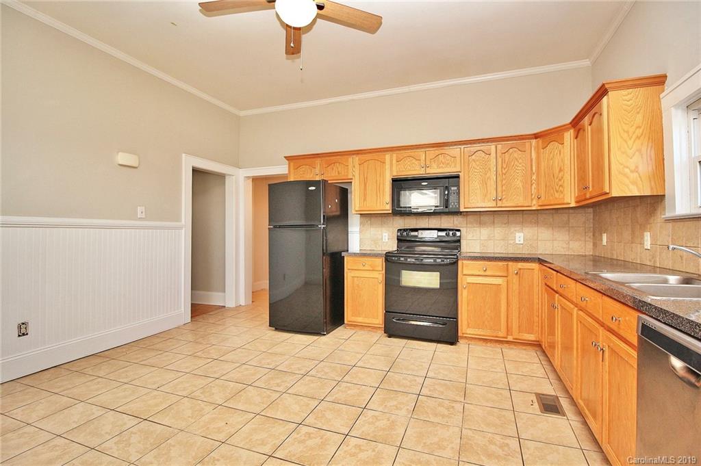 694 Main Street Southwest Concord, NC 28027 - Photo 13 of 33 a kitchen with a refrigerator a stove top oven a sink and dishwasher