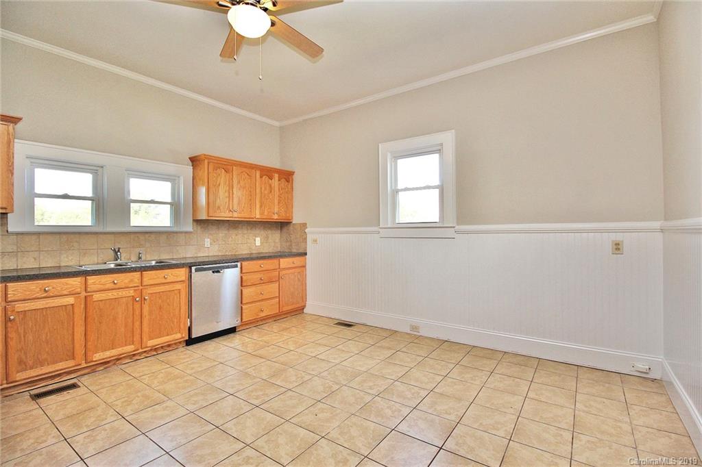 694 Main Street Southwest Concord, NC 28027 - Photo 16 of 33 a kitchen with granite countertop a sink cabinets and window