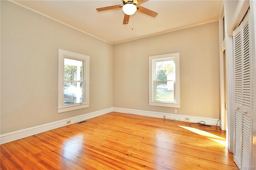 694 Main Street Southwest Concord, NC 28027 - Photo 19 of 33 a view of an empty room with wooden floor and a window