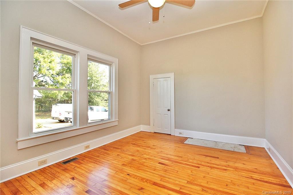 694 Main Street Southwest Concord, NC 28027 - Photo 22 of 33 a view of an empty room with window and wooden floor