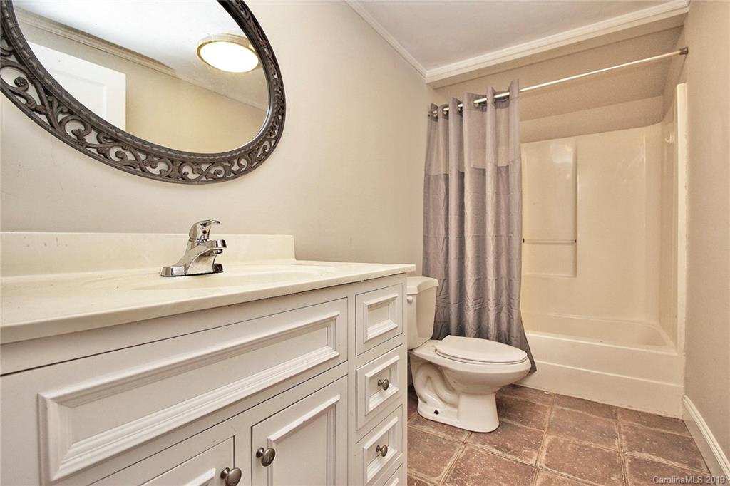 694 Main Street Southwest Concord, NC 28027 - Photo 24 of 33 a bathroom with a toilet a sink and a mirror