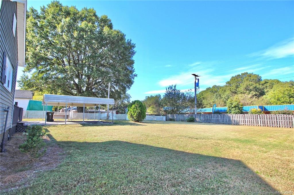 694 Main Street Southwest Concord, NC 28027 - Photo 28 of 33 a view of a swimming pool with lawn chairs and plants