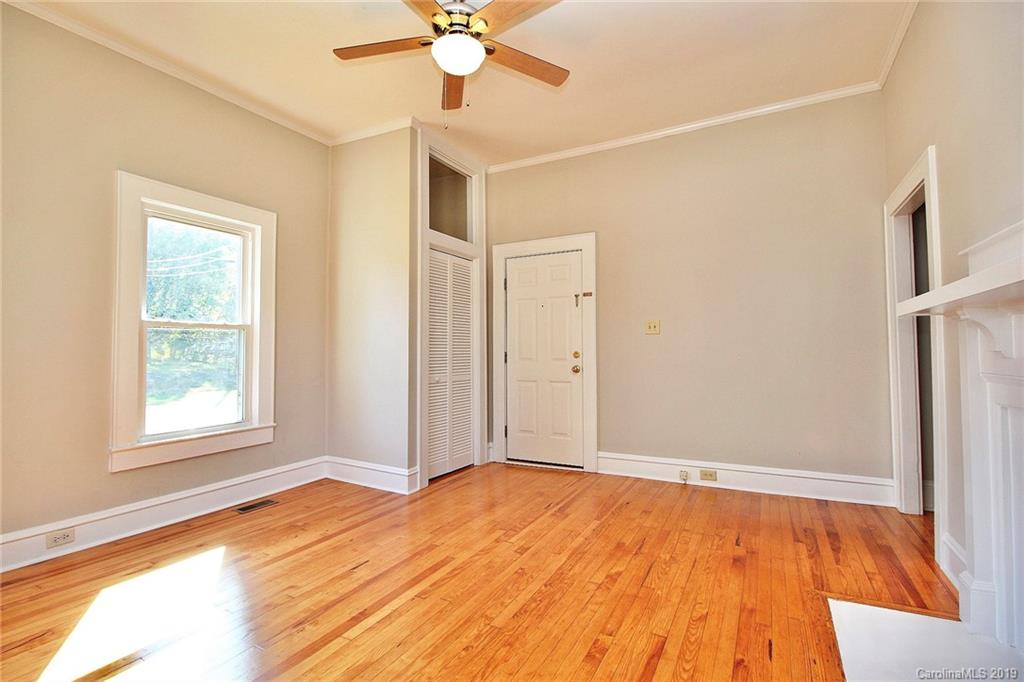 694 Main Street Southwest Concord, NC 28027 - Photo 5 of 33 wooden floor in an empty room with a window