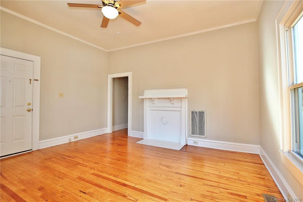 694 Main Street Southwest Concord, NC 28027 - Photo 7 of 33 a view of an empty room with window and wooden floor