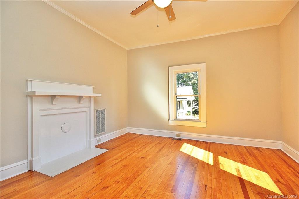 694 Main Street Southwest Concord, NC 28027 - Photo 8 of 33 a view of an empty room with wooden floor and a window