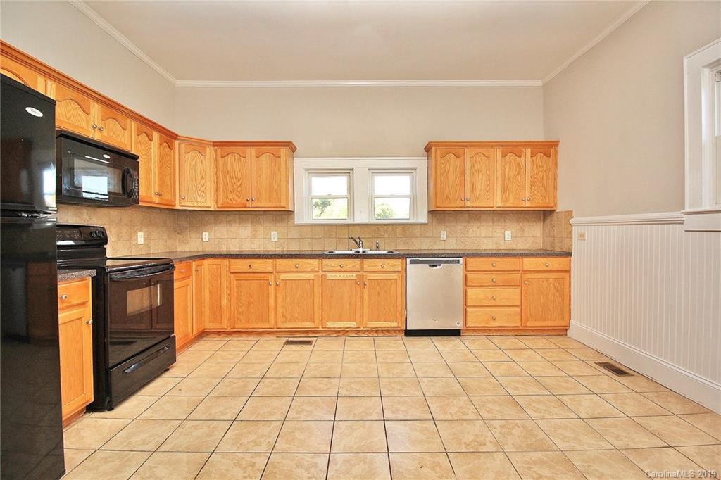 694 Main Street Southwest Concord, NC 28027 - Photo 10 of 33 a kitchen with a stove a sink and a refrigerator
