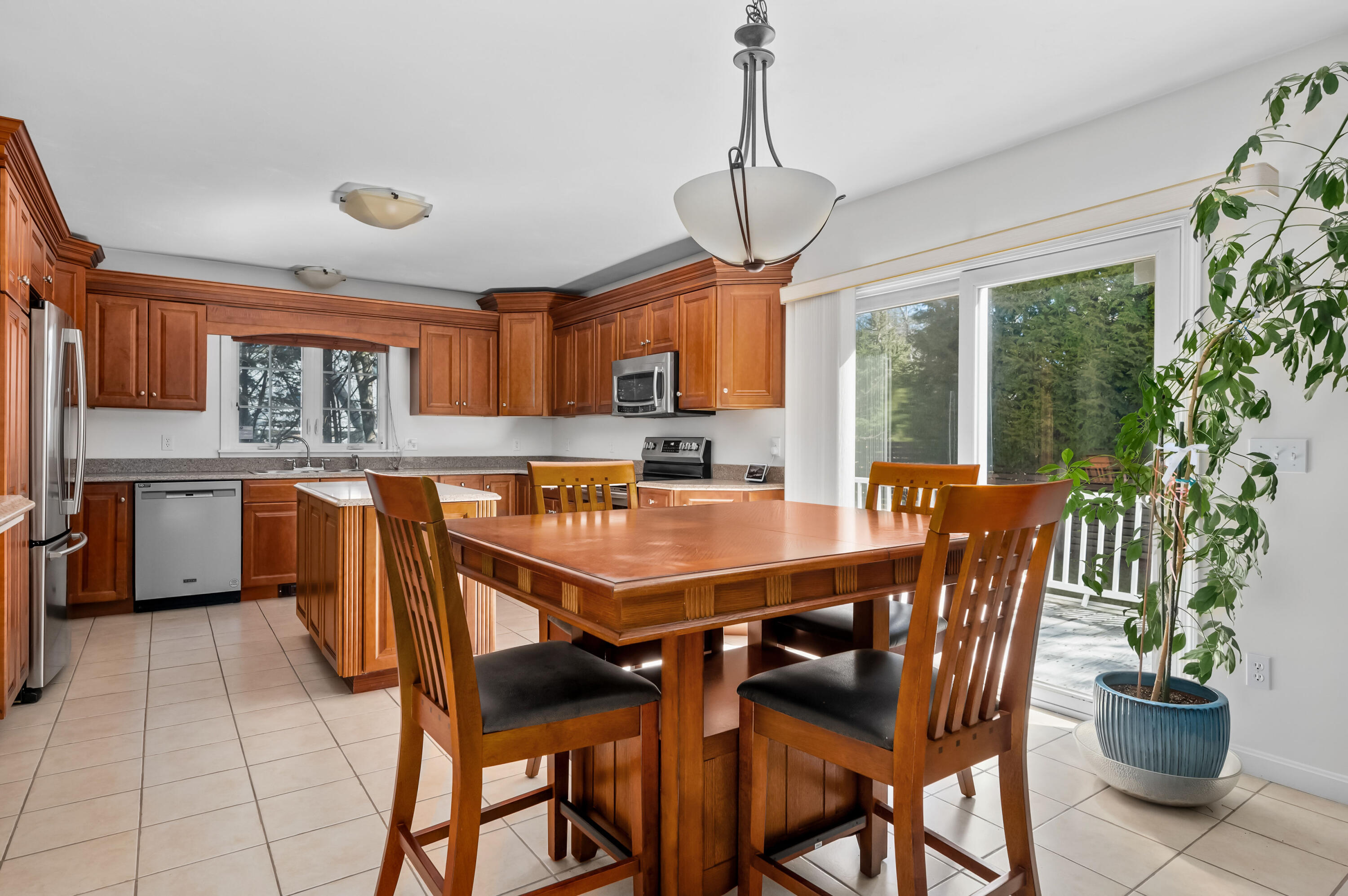 2 Centerville Avenue Centerville, MA 02632 - Photo 12 of 40 a dining room with stainless steel appliances granite countertop a dining table chairs and granite counter tops
