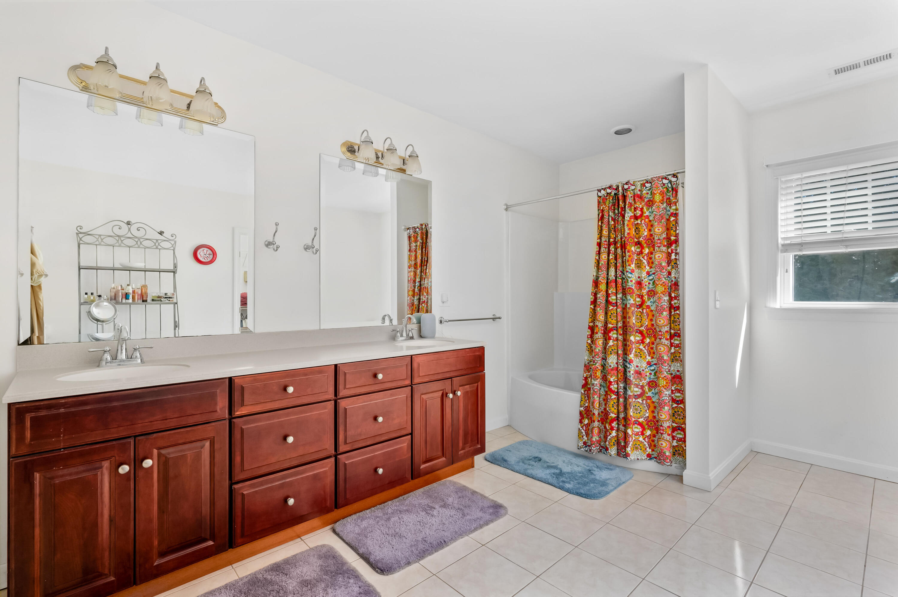 2 Centerville Avenue Centerville, MA 02632 - Photo 25 of 40 a spacious bathroom with double vanity sink a two mirror a window and a bathtub