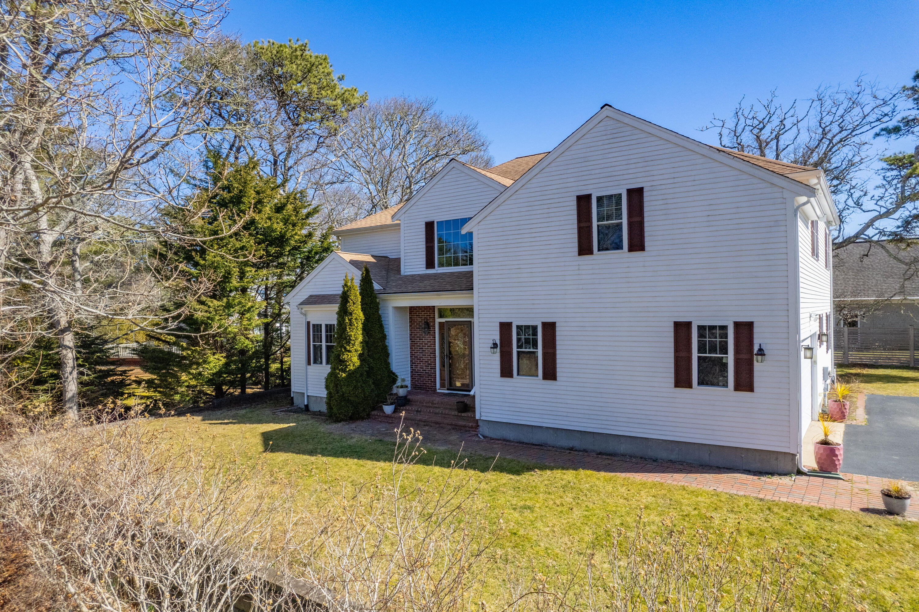 2 Centerville Avenue Centerville, MA 02632 - Photo 4 of 40 a view of house with yard outdoor seating and covered with trees