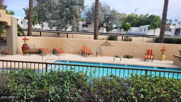 an aerial view of a house with swimming pool and a patio