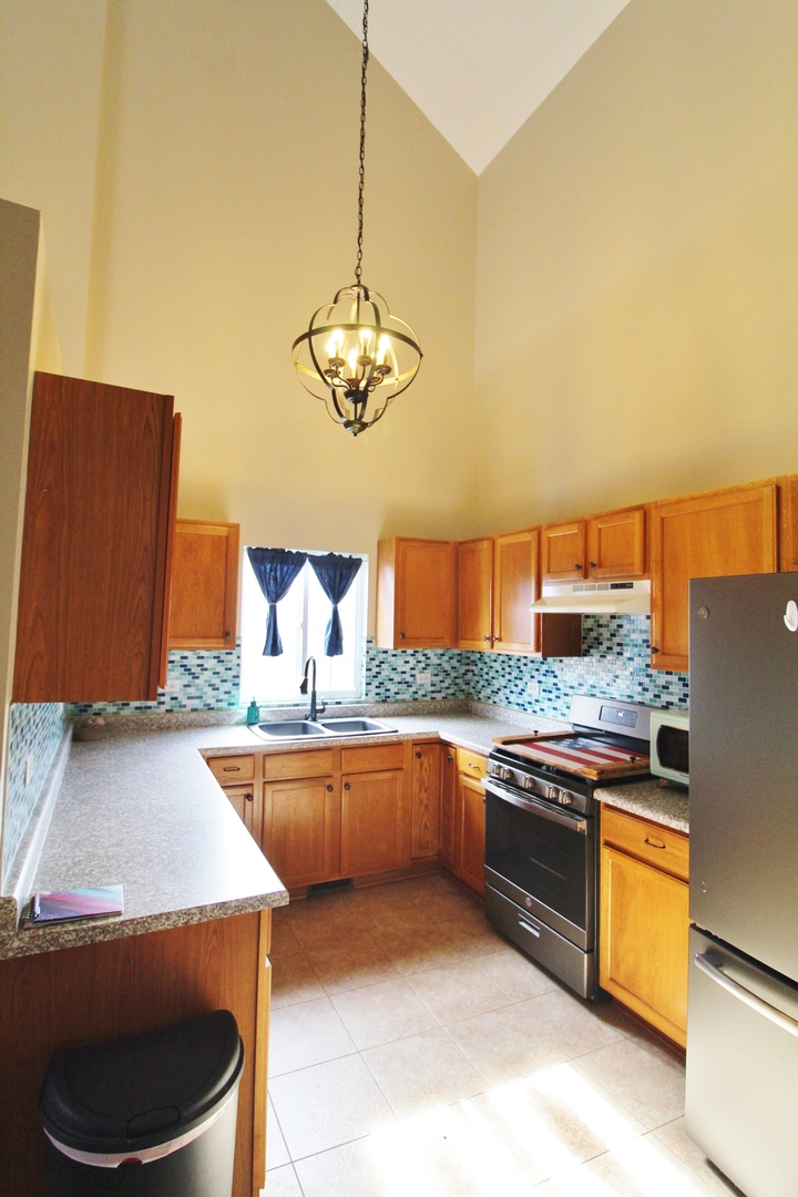 2005 Mountain Road Morris, IL 60450 - Photo 12 of 30 a kitchen with stainless steel appliances granite countertop a sink and a stove