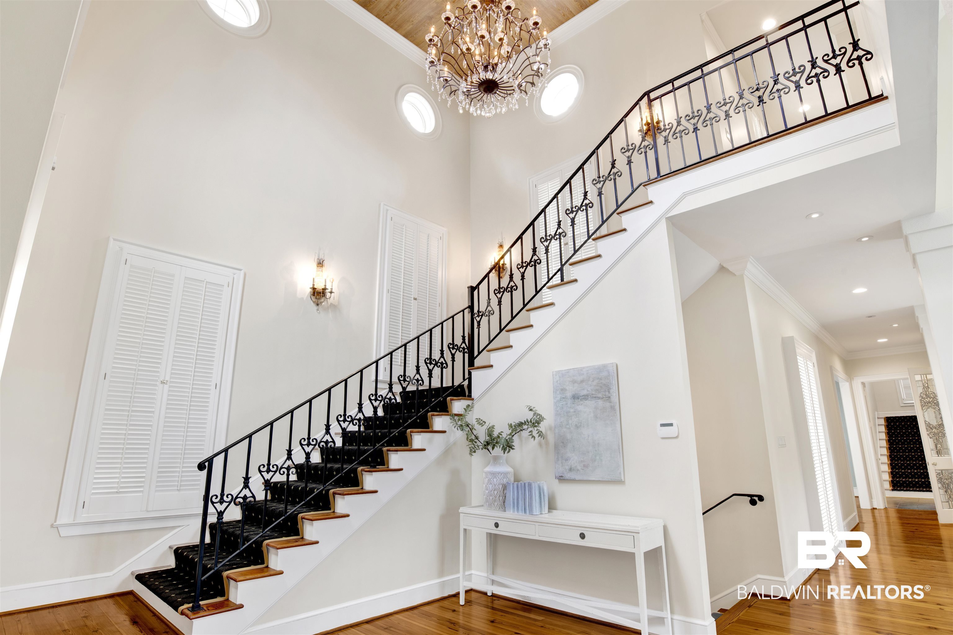3816 Austill Lane Mobile, AL 36608 - Photo 10 of 80 Stairs featuring ornamental molding, wood finished floors, a high ceiling, a chandelier, and recessed lighting