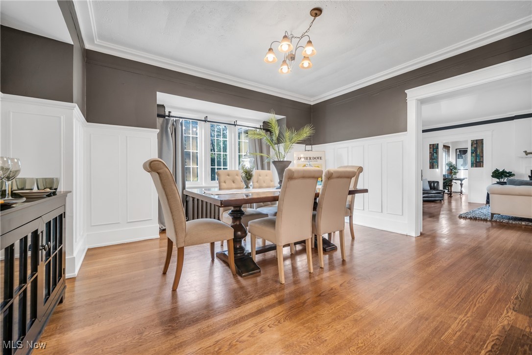 12699 Cedar Road Cleveland, OH 44106 - Photo 5 of 36 Dining area with a notable chandelier, hardwood floors, and crown molding