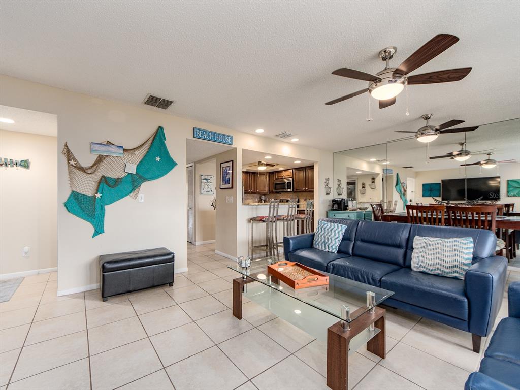 2406 Gulf Boulevard, Unit 204 Indian Rocks Beach, FL 33785 - Photo 11 of 39 a living room with furniture and kitchen view