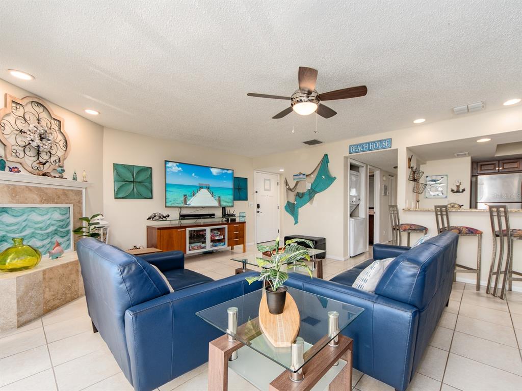 2406 Gulf Boulevard, Unit 204 Indian Rocks Beach, FL 33785 - Photo 12 of 39 a living room with furniture a ceiling fan and a window
