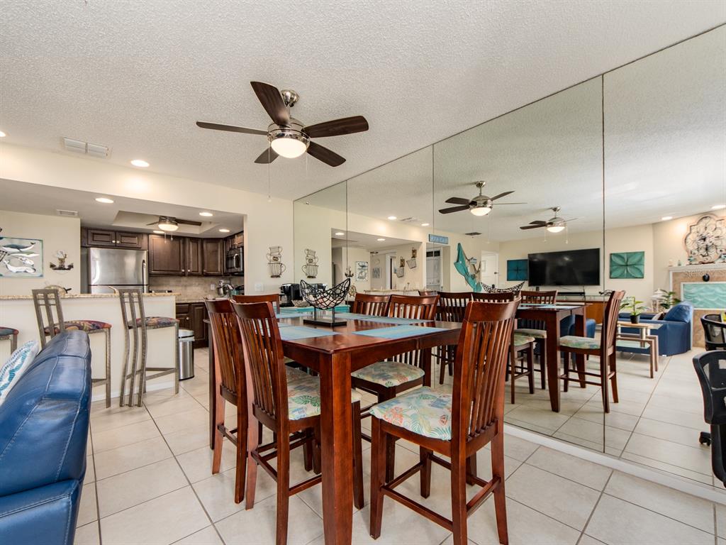 2406 Gulf Boulevard, Unit 204 Indian Rocks Beach, FL 33785 - Photo 17 of 39 a view of a dining area with furniture and a chandelier