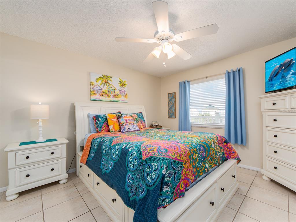2406 Gulf Boulevard, Unit 204 Indian Rocks Beach, FL 33785 - Photo 21 of 39 a bedroom with a bed and a dresser