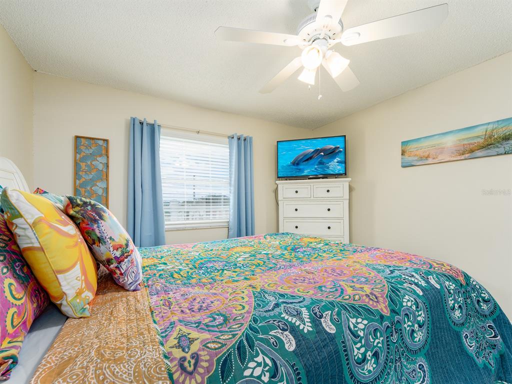 2406 Gulf Boulevard, Unit 204 Indian Rocks Beach, FL 33785 - Photo 23 of 39 a bedroom with a bed dresser and a window