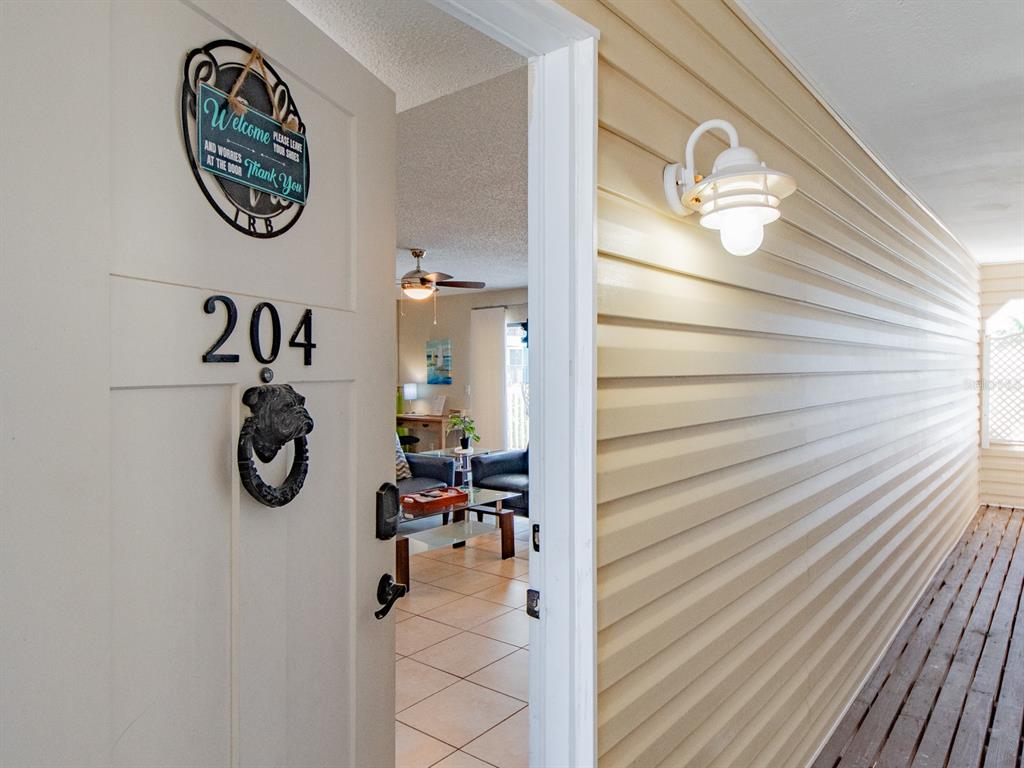 2406 Gulf Boulevard, Unit 204 Indian Rocks Beach, FL 33785 - Photo 4 of 39 a view of entryway with wooden floor