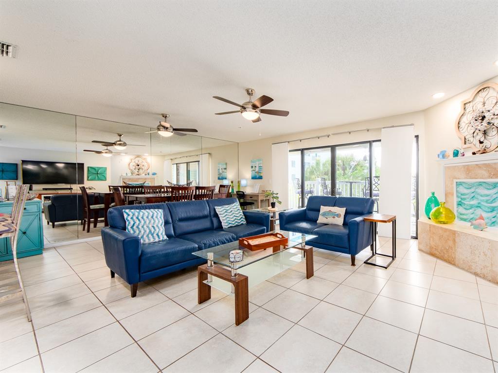 2406 Gulf Boulevard, Unit 204 Indian Rocks Beach, FL 33785 - Photo 6 of 39 a living room with furniture and a table