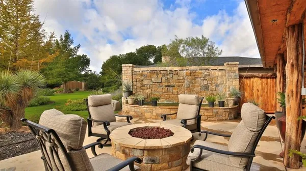 a view of a backyard with plants and patio