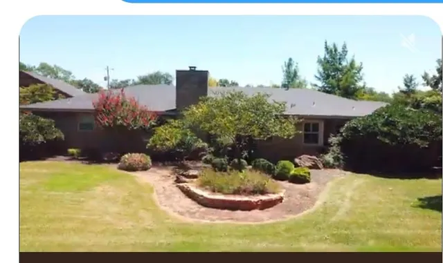 a living room with lots of furniture and view of kitchen