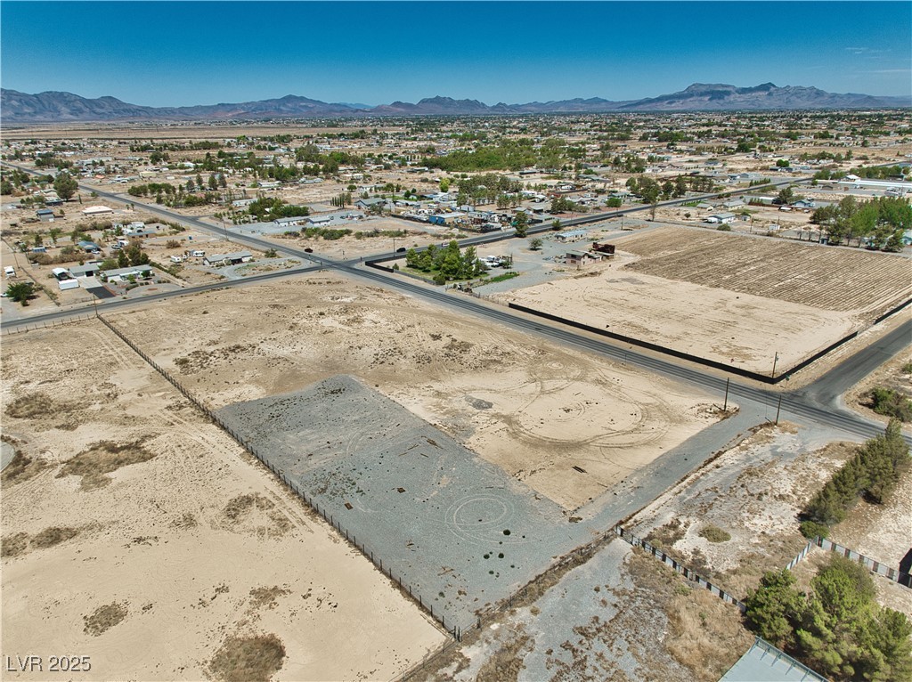 2121 East Manse Road Pahrump, NV 89048 - Photo 11 of 18 Aerial view of residential area with a mountainous background and a desert landscape