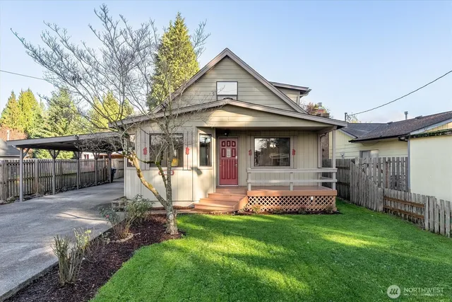 a front view of a house with a yard table and chairs