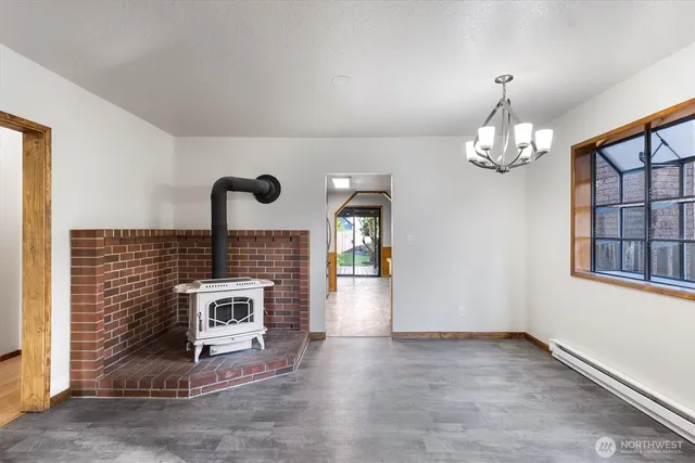 a living room with furniture a fireplace and a chandelier
