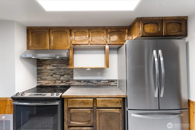 a kitchen with a stove and a refrigerator