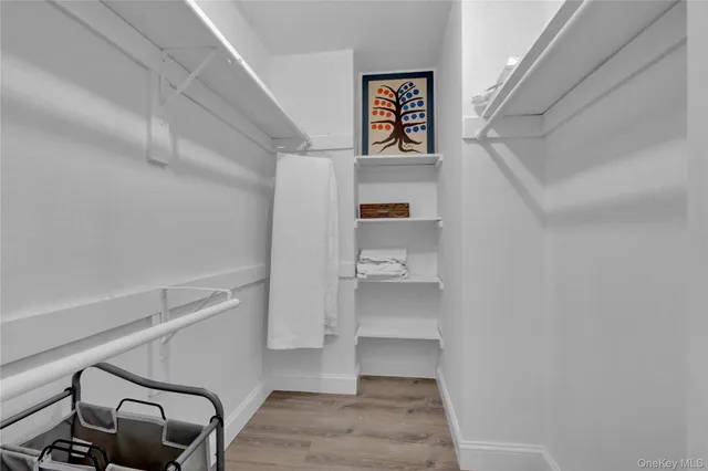 a view of a hallway with stairs and furniture