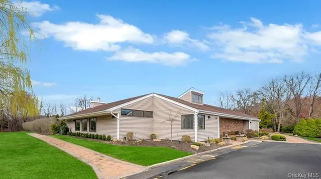 a front view of a house with a garden and yard