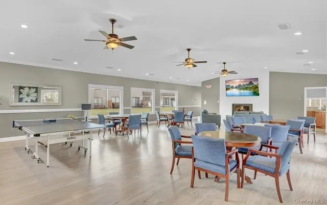 a living room with lots of furniture and view of kitchen