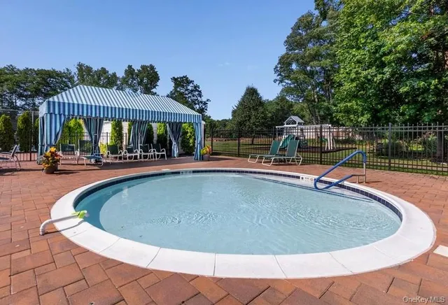 a view of a swimming pool with sitting space