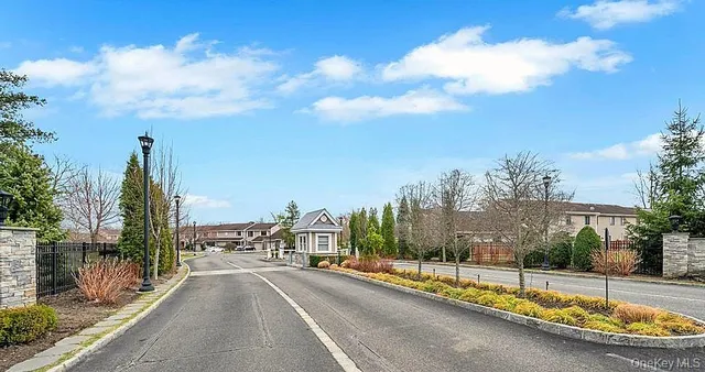 a view of a swimming pool and trees in a backyard