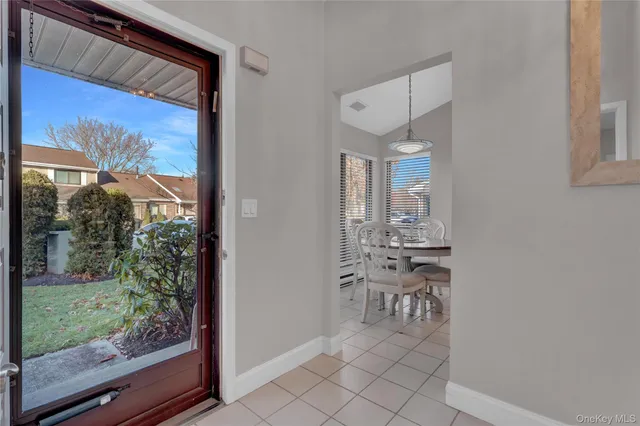 a dining room with furniture and a window