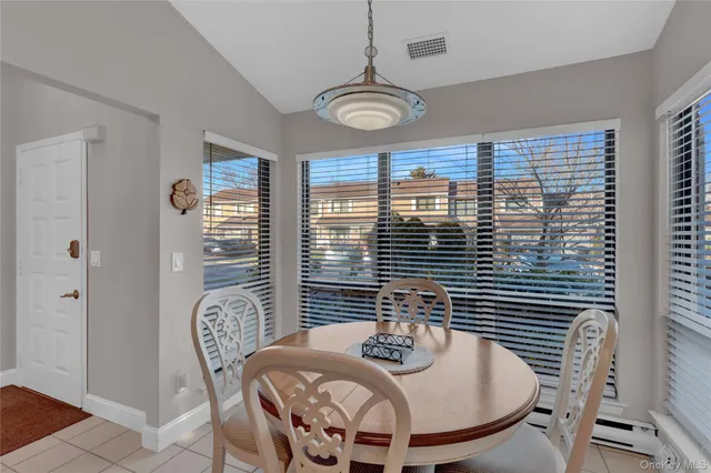 a view of a dining room with furniture and window