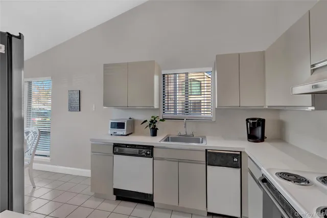 a kitchen with a sink cabinets and window