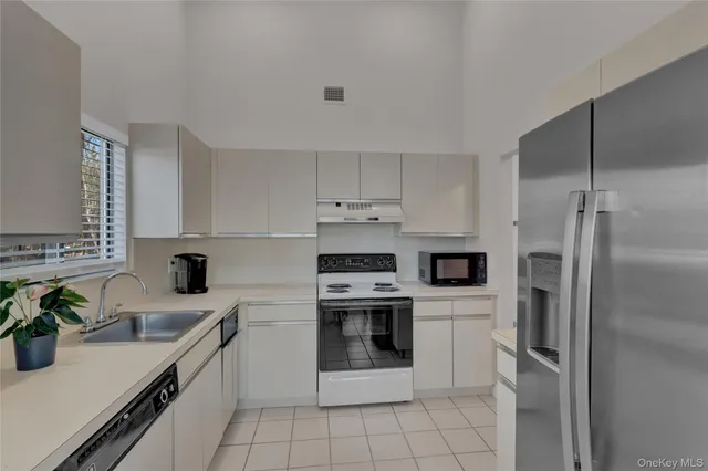 a kitchen with a sink stainless steel appliances and cabinets