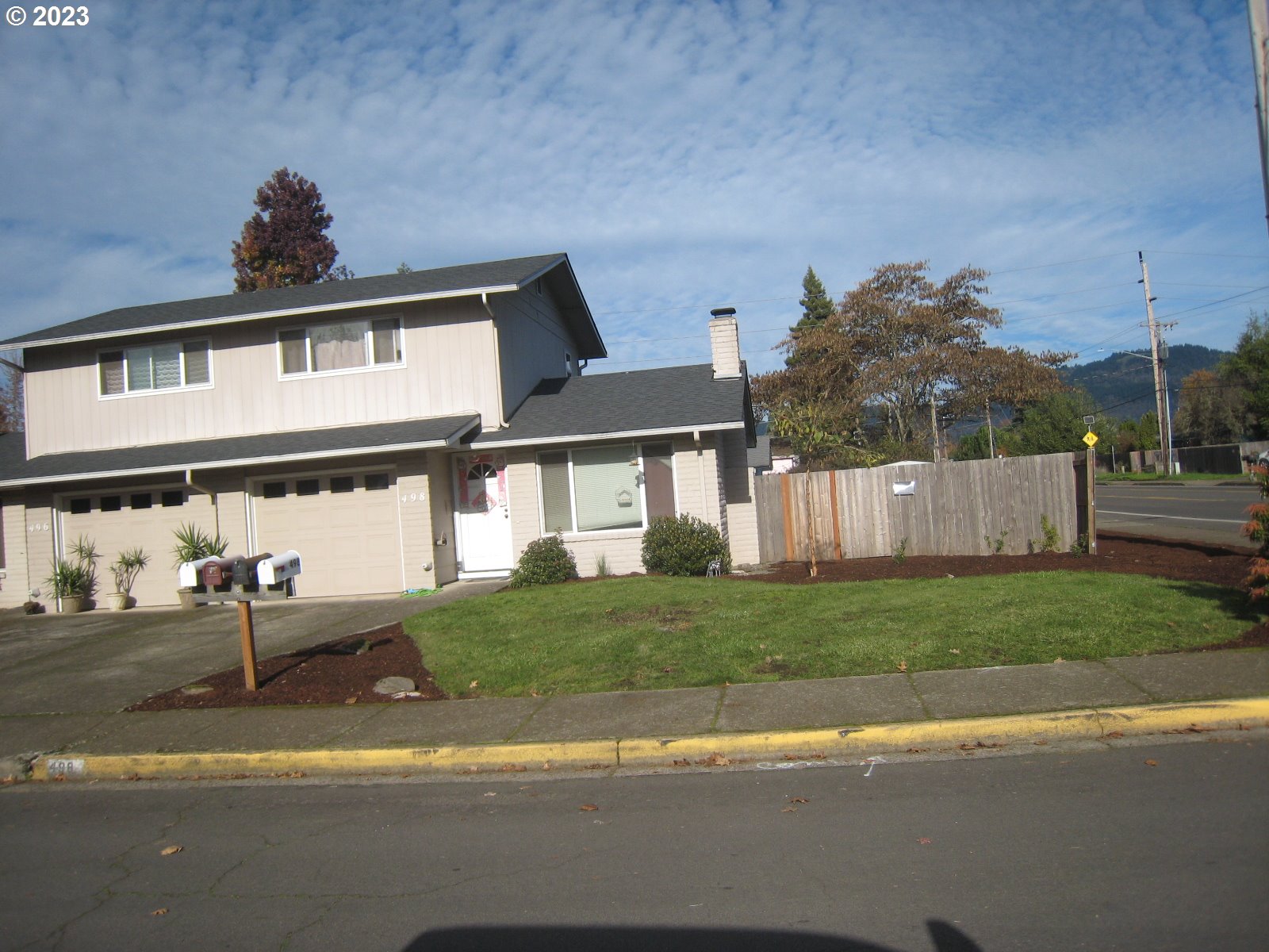 496 S Street Springfield, OR 97477 - Photo 2 of 11 a front view of a house with a yard and a garage