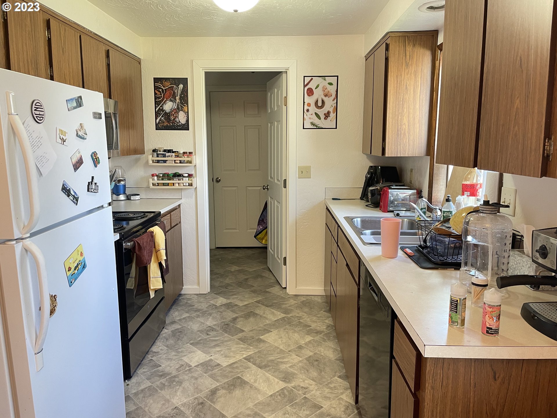 496 S Street Springfield, OR 97477 - Photo 3 of 11 a view of a kitchen with fridge and workspace