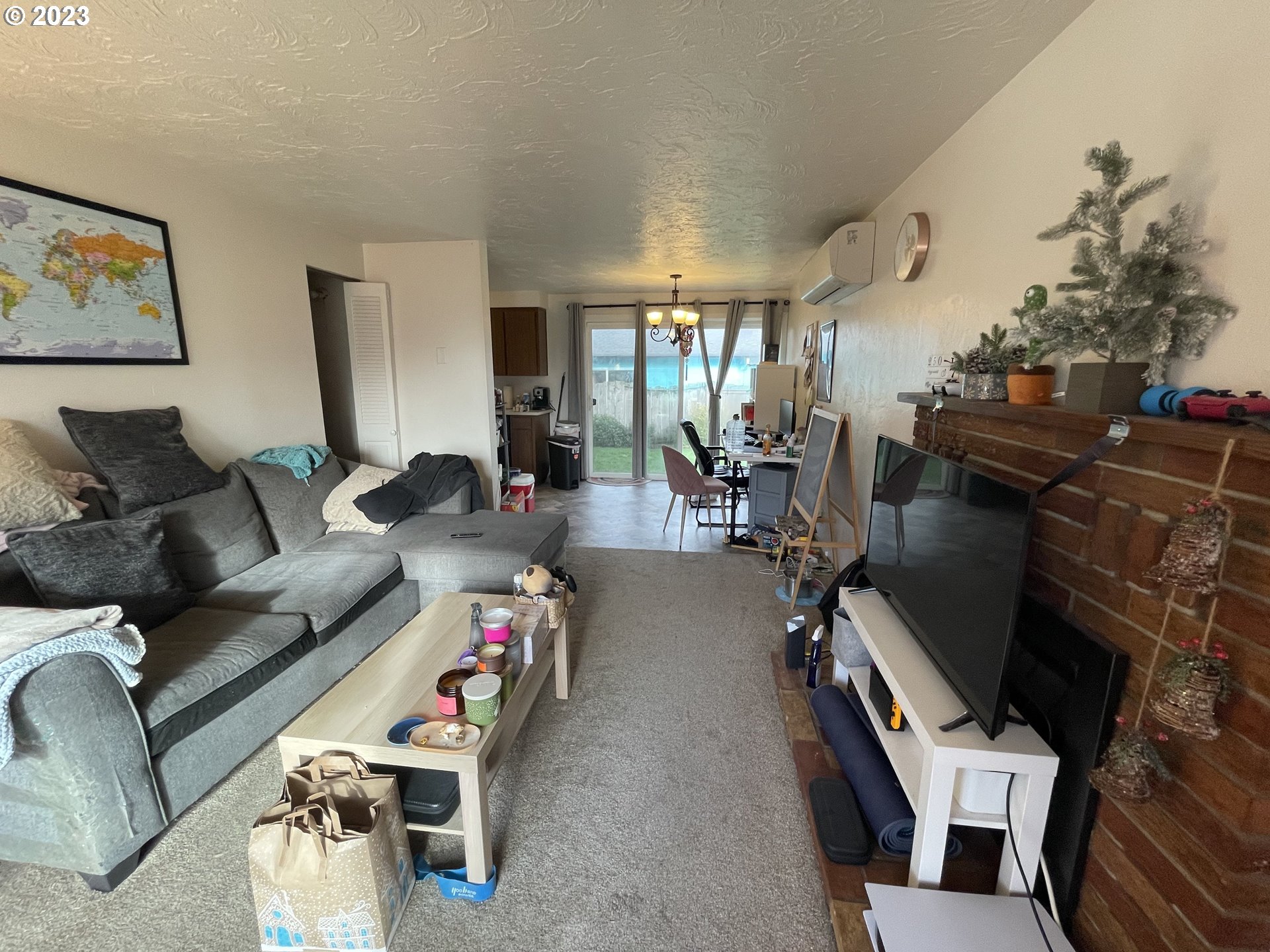 496 S Street Springfield, OR 97477 - Photo 4 of 11 a living room with furniture a flat screen tv and a floor to ceiling window