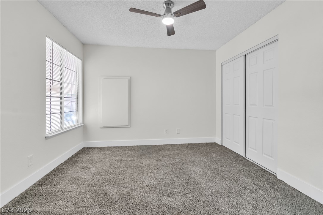 370 Rushing Creek Court Henderson, NV 89014 - Photo 27 of 32 Plush carpeting anchors this versatile room illuminated by natural light from a large side window.