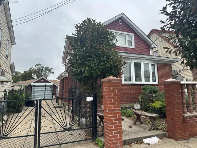 a view of a house with a yard and potted plants