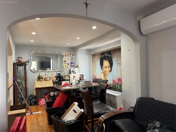 a living room with furniture a rug and gym equipment