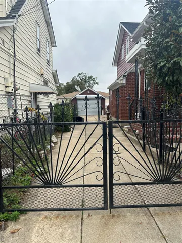 a view of a house with wooden fence