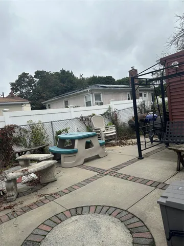 a view of a patio with dining table and chairs with wooden floor