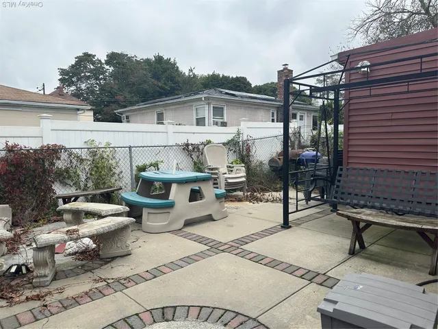 a view of a patio with a dining table and chairs with wooden floor
