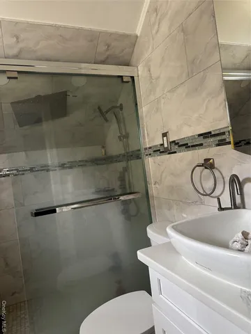 a bathroom with a sink a toilet and a shower