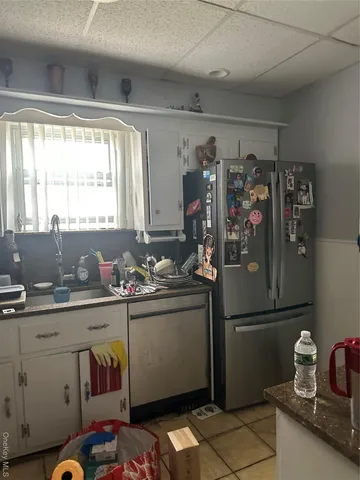 a kitchen with a sink and a refrigerator